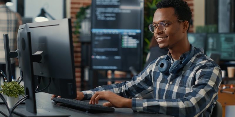 portrait-of-software-engineer-writing-code-arranging-glasses-and-being-happy-about-parsing-results-e1698777675815.jpg